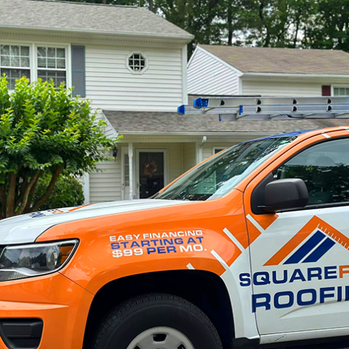roofing company truck at house