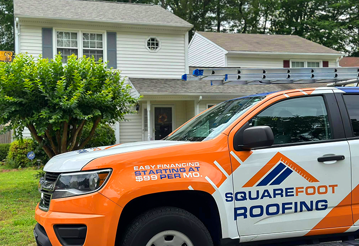 roofing company truck at house