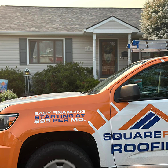 roofing company truck at house