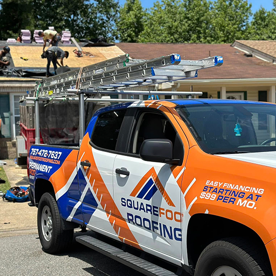Roofers repairing roof with truck
